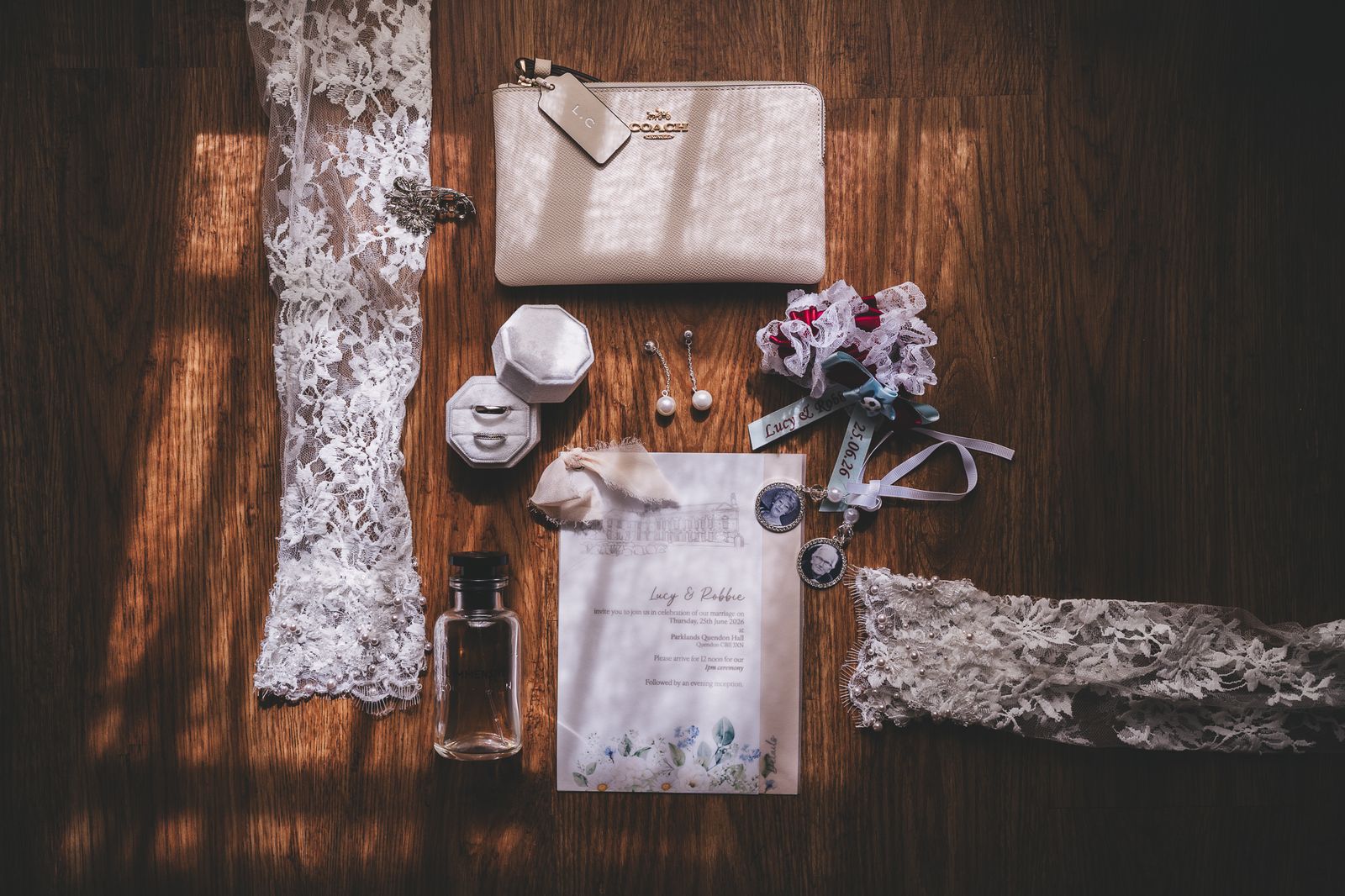 Bridal details laid out on a wooden floor